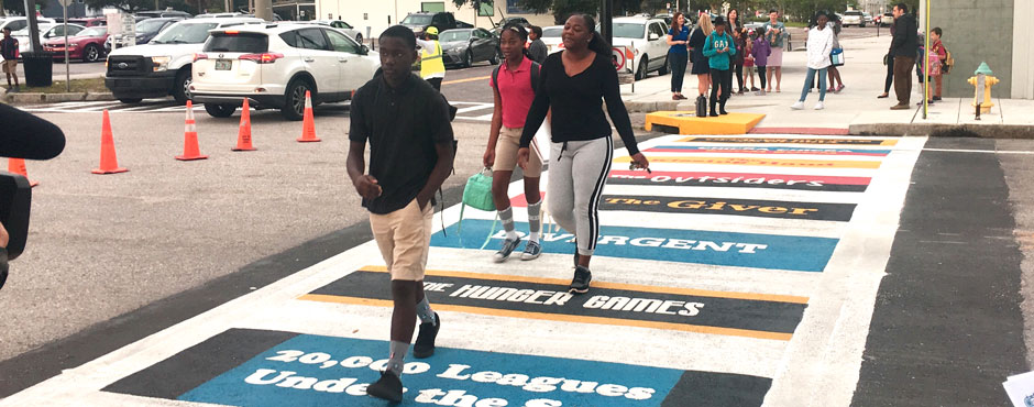 School kids walking in newly painted crosswalk on the way to school