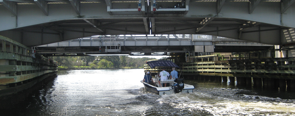 boat on the river going under a bridge