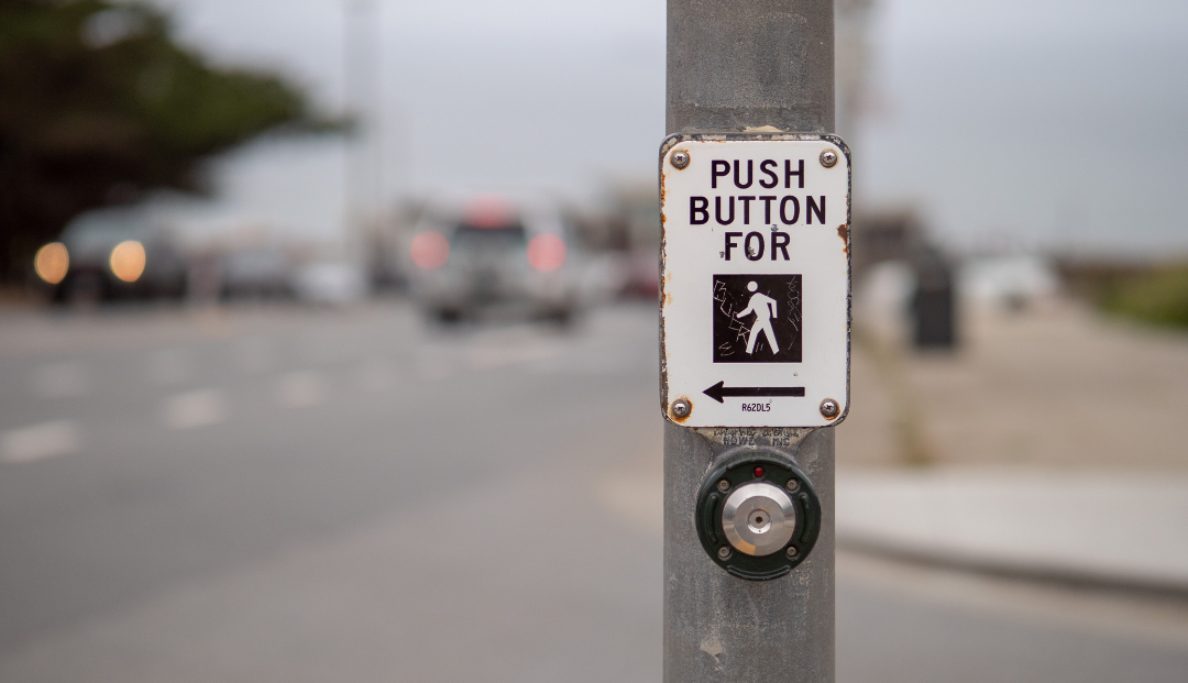 crosswalk button that says push button for walk